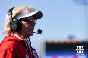 Nebraska Cornhusker head coach Rhonda Revelle talks to the tv commentators in the middle of the third against the Purdue Boilermakers during a college softball game Monday, March 31, 2025 in Lincoln, Nebraska. Photo by John S. Peterson.
