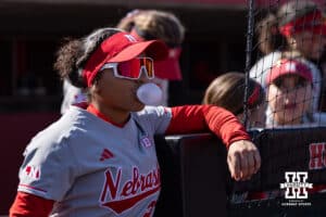 Nebraska Cornhusker Natalia Hill (27) blows a bubble waiting for the game to start against the Purdue Boilermakers during a college softball game Monday, March 31, 2025 in Lincoln, Nebraska. Photo by John S. Peterson.