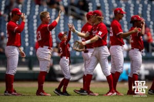 Nebraska Cornhuskers give each other high fives after the win over the Oregon Ducks during the Big Ten Baseball Tournament on Saturday, May 24, 2025 in Omaha, Nebraska. Photo by John S. Peterson.