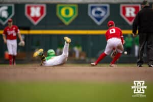 Oregon Duck infielder Maddox Molony (9) slides to second base against Nebraska Cornhusker utility Cayden Brumbaugh (0) in the seventh inning during the Big Ten Baseball Tournament on Saturday, May 24, 2025 in Omaha, Nebraska. Photo by John S. Peterson.