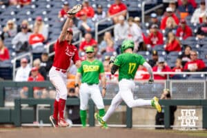Nebraska Cornhusker first baseman Case Sanderson (14) makes a out againt Oregon Duck infielder Drew Smith (17) in the fourth inning during the Big Ten Baseball Tournament on Saturday, May 24, 2025 in Omaha, Nebraska. Photo by John S. Peterson.