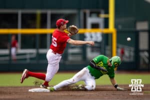 Nebraska Cornhusker infielder Dylan Carey (15) throws to first base to turn a double play against the Oregon Ducks in the fourth inning during the Big Ten Baseball Tournament on Saturday, May 24, 2025 in Omaha, Nebraska. Photo by John S. Peterson.
