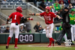 Nebraska Cornhusker outfielder Robby Bolin (5) celebrates a run with Riley Silva in the second inning against the Oregon Ducks during the Big Ten Baseball Tournament on Saturday, May 24, 2025 in Omaha, Nebraska. Photo by John S. Peterson.