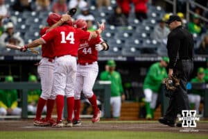 Nebraska Cornhusker outfielder Gabe Swansen (44) celebrates his home run with Case Sanderson and Riley Silva in the first inning against the Oregon Ducks during the Big Ten Baseball Tournament on Saturday, May 24, 2025 in Omaha, Nebraska. Photo by John S. Peterson.