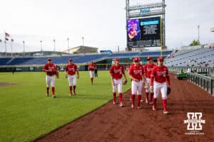 Nebraska Cornhuskers head to the dugout for the start of the game against the Oregon Ducks during the Big Ten Baseball Tournament on Saturday, May 24, 2025 in Omaha, Nebraska. Photo by John S. Peterson.