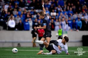 Schuyler Defender Ricardo Delgado (22) makes a crucial slide tackle early in the game to keep Bennington off the board during the NSAA Boys Class B soccer finals on Tuesday, May 20, 2025, in Omaha, Nebraska. Photo by Braden Cochran.