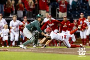Nebraska Cornhusker Dylan Carey (15) slides home for the winning run in the walk-off win against the Michigan State Spartans in the tenth inning during the Big Ten Baseball Tournament on Tuesday, May 20, 2025 in Omaha, Nebraska. Photo by John S. Peterson.