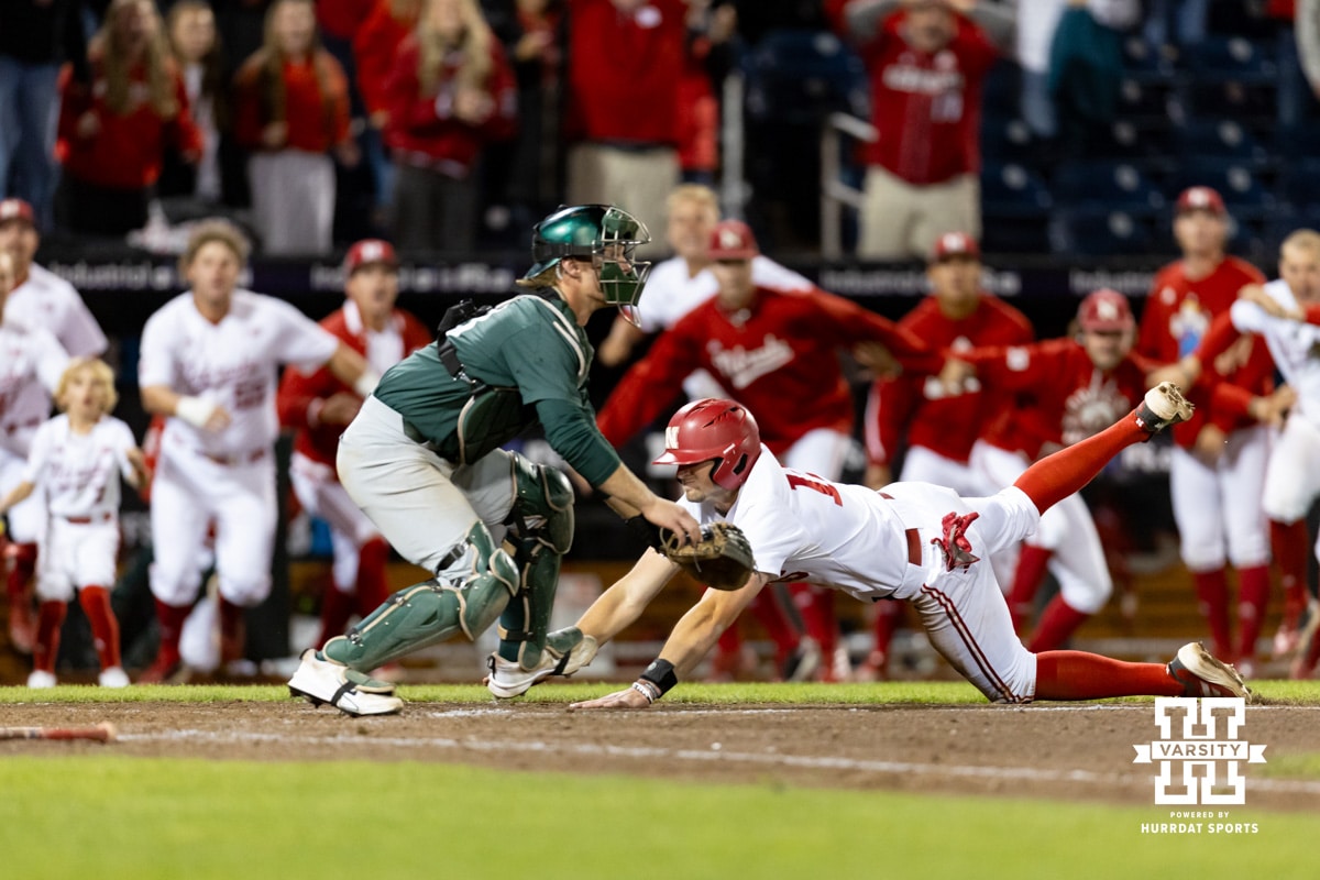 Nebraska Cornhusker Dylan Carey (15) slides home for the winning run in the walk-off win against the Michigan State Spartans in the tenth inning during the Big Ten Baseball Tournament on Tuesday, May 20, 2025 in Omaha, Nebraska. Photo by John S. Peterson.