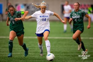 Marian's Paige Miller dribbles through a couple Lincoln Southwest defenders during the NSAA Girls Class A soccer finals on Monday, May 19, 2025, in Omaha, Nebraska. Photo by Braden Cochran.