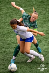 An Omaha Marian and Lincoln Southewest player get physical trying to move for the ball during the NSAA Girls Class A soccer finals on Monday, May 19, 2025, in Omaha, Nebraska. Photo by Braden Cochran.