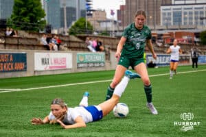 Southwest's Ansley Throener battles for the ball against a Marion player the ball upfield during the NSAA Girls Class A soccer finals on Monday, May 19, 2025, in Omaha, Nebraska. Photo by Braden Cochran.