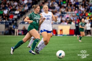 Lincoln Southwest's Tea Tweton (18) dribbles the ball, challenged by Marian's McKinlee Schneckenberger (21) during the NSAA Girls Class A soccer finals on Monday, May 19, 2025, in Omaha, Nebraska. Photo by Braden Cochran.