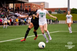 Gretna East Kendall Dobberstein (12) tries to make her way around Chloe Kolm (10) during the NSAA Girls Class B soccer finals on Monday, May 19, 2025, in Omaha, Nebraska. Photo by Braden Cochran.