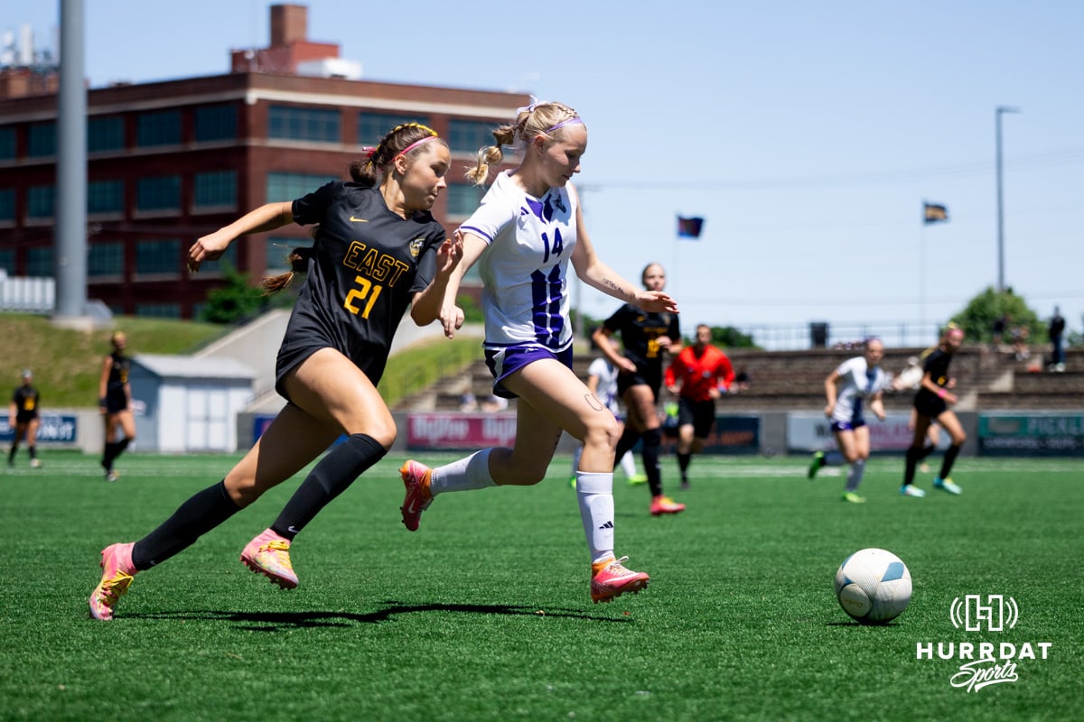 Gretna East'a Lily Frederick (21) tries to push around the outside of Blair's Renn Dresden (14) late during the NSAA Girls Class B soccer semi-finals on Saturday, May 17, 2025, in Omaha, Nebraska. Photo by Braden Cochran.