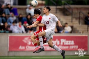 South Sioux City Defender David Hernandez (13) jumps for a header during the NSAA Boys Class A soccer semi-finals on Friday, May 16, 2025, in Omaha, Nebraska. Photo by Braden Cochran.