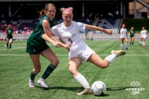 Elkhorn South's Aubrey Marsh works to clear the ball upfield against Lincoln Southwest attacker Ansley Throerner (9) during the NSAA Girls Class A soccer semi-finals on Friday, May 16, 2025, in Omaha, Nebraska. Photo by Braden Cochran.