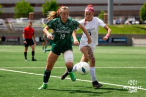Lincoln Southwest's Kianna Perez (19) makes a move around Elkhorn South's Emery Grace (11) during the NSAA Girls Class A soccer semi-finals on Friday, May 16, 2025, in Omaha, Nebraska. Photo by Braden Cochran.