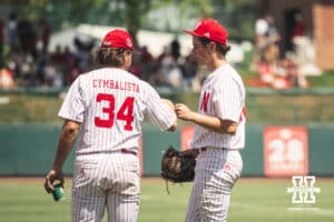 Nebraska Cornhusker catcher Colin Cymbalista (34) gives Ty Horn a fist bump against Michigan during a college baseball game Saturday, May 10, 2025, in Lincoln, Nebraska. Photo by Jansen Coburn.