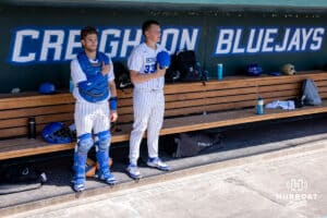 Creighton Bluejay catcher Connor Capece (2) and pitcher Wilson Magers standing for the National Anthem before taking on the Xavier Musketeers during a college baseball game on Sunday, May 11, 2025 in Omaha, Nebraska. Photo by John S. Peterson.