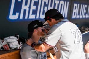 Omaha Mavericks Blake Stenger applies eye black to a teammate before a baseball game Tuesday , April 29th, 2025 in Omaha, Nebraska. Photo by Brandon Tiedemann.