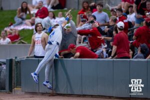 Creighton Bluejay first baseman Will MacLean (17) makes a catch over the fans in the seventh inning against the Nebraska Cornhuskers during a college baseball game on Tuesday, May 6, 2025 in Lincoln, Nebraska. Photo by John S. Peterson.
