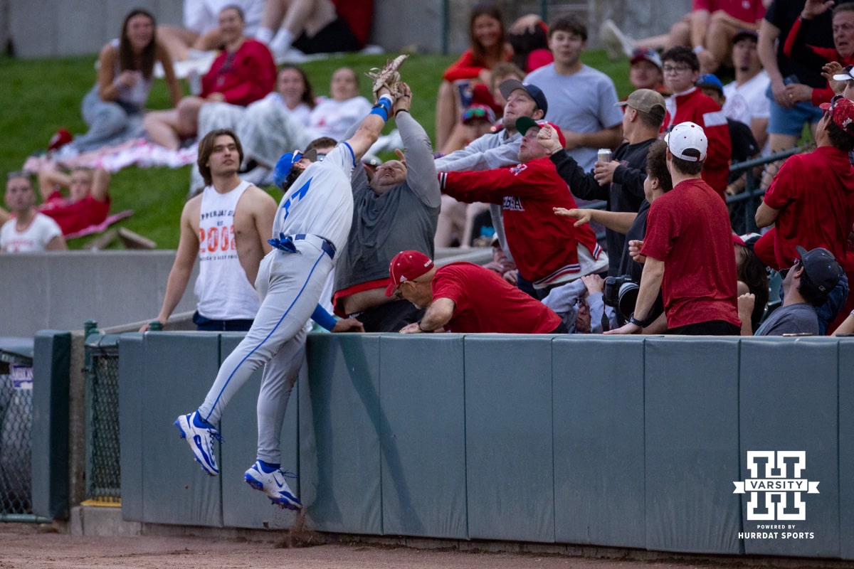 Creighton Bluejay first baseman Will MacLean (17) makes a catch over the fans in the seventh inning against the Nebraska Cornhuskers during a college baseball game on Tuesday, May 6, 2025 in Lincoln, Nebraska. Photo by John S. Peterson.