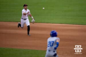 Nebraska Cornhusker utility Cayden Brumbaugh (0) tosses the ball to first to beat out Creighton Bluejay outfielder Tate Gillen (20) in the sixth inning during a college baseball game on Tuesday, May 6, 2025 in Lincoln, Nebraska. Photo by John S. Peterson.