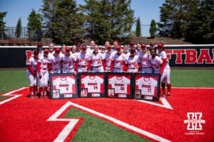 Nebraska Cornhuskers four seniors Abbie Squier, Ava Bredwell, Haidyn Warner, and Mckinley Malecha pose for a photo with their teammates during a college softball game on Sunday, May 4, 2025 in Lincoln, Nebraska. Photo by John S. Peterson.