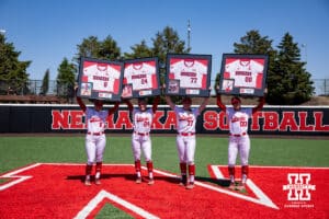 Nebraska Cornhuskers four seniors Abbie Squier, Ava Bredwell, Haidyn Warner, and Mckinley Malecha hold up their framed jerseys for the Senior Day celebration after the win over Maryland Terrapins during a college softball game on Sunday, May 4, 2025 in Lincoln, Nebraska. Photo by John S. Peterson.