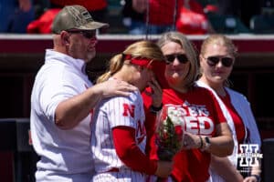 Nebraska Cornhusker Abbie Squier's father puts his arm around her during the Senior Day celebration after the win over the Maryland Terrapins during a college softball game on Sunday, May 4, 2025 in Lincoln, Nebraska. Photo by John S. Peterson.