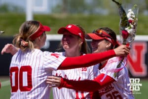 Nebraska Cornhusker Mckinley Malecha (0) receives hugs from Talia Tokheim and Alina Felix during the Senior Day celebration after the win over the Maryland Terrapins during a college softball game on Sunday, May 4, 2025 in Lincoln, Nebraska. Photo by John S. Peterson.