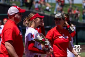 Nebraska Cornhusker Mckinley Malecha (0) walks out the infield with her parents for the Senior Day celebration after the win over the Maryland Terrapins during a college softball game on Sunday, May 4, 2025 in Lincoln, Nebraska. Photo by John S. Peterson.