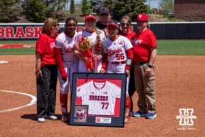 Nebraska Cornhusker Mckinley Malecha (0) poses with teammates Hannah Camenzind, Katelyn Caneda, and family during the Senior Day celebration during a college softball game on Sunday, May 4, 2025 in Lincoln, Nebraska. Photo by John S. Peterson.