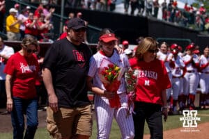 Nebraska Cornhusker Haidyn Warner (77) walks out to the infield with her parents for the Senior Day celebration after the win over the Maryland Terrapins during a college softball game on Sunday, May 4, 2025 in Lincoln, Nebraska. Photo by John S. Peterson.