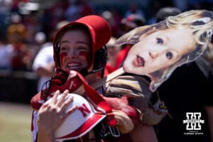 Nebraska Cornhusker Ava Kuszak's teammates stack equipment on her as she is interviewed live on tv after hitting a home run for the walk-off win over the Maryland Terrapins in the sixth inning during a college softball game on Sunday, May 4, 2025 in Lincoln, Nebraska. Photo by John S. Peterson.
