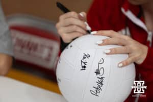 Nebraska Cornhusker Bergen Reilly (2) signs a ball for a fan after the spring match against the South Dakota State Jackrabbits on Saturday, May 3, 2025 in Ord, Nebraska. Photo by John S. Peterson