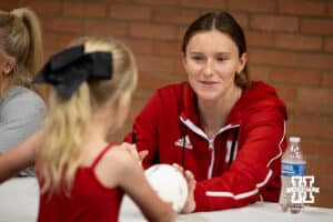 Nebraska Cornhusker Bergen Reilly (2) signs a ball for a young fan after the spring match against the South Dakota State Jackrabbits on Saturday, May 3, 2025 in Ord, Nebraska. Photo by John S. Peterson