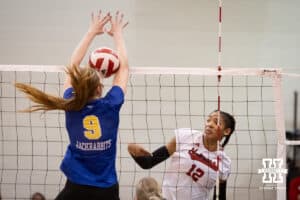Nebraska Cornhusker Taylor Landfair (12) spikes the ball against South Dakota State Jackrabbit middle blocker Taylor Byl (9) during the spring game on Saturday, May 3, 2025 in Ord, Nebraska. Photo by John S. Peterson