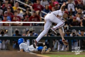 UCLA Bruin first baseman Mulivai Levu (39) slide to third base against Arkansas Razorbacks third baseman Roman Martin in the ninth inning during the College World Series on Tuesday, June 17, 2025 in Omaha, Nebraska. Photo by John S. Peterson.