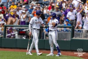 LSU Tiger outfielder Ethan Frey (16) celebrates a run with Luis Hernandez in the eighth inning against the UCLA Bruins during the College World Series on Tuesday, June 17, 2025 in Omaha, Nebraska. Photo by John S. Peterson.