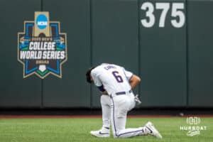 LSU Tiger outfielder Derek Curiel (6) prays before a game on Thursday June 18th 2025 in Omaha Nebraska. Photo by Brandon Tiedemann.