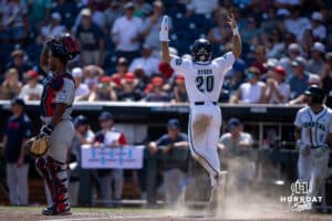 Coastal Carolina Chanticleer outfielder Wells Sykes (20) celebrates scoring a run against the Arizona Wildcats in the eighth inning during the College World Series on Friday, June 13, 2025 in Omaha, Nebraska. Photo by John S. Peterson.
