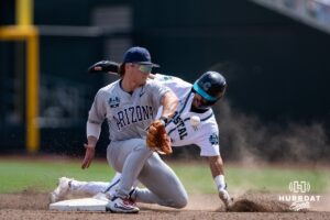 Coastal Carolina Chanticleer infielder Dean Mihos (8) slides to second against Arizona Wildcat infielder Garen Caulfield (1) in the sixth inning during the College World Series on Friday, June 13, 2025 in Omaha, Nebraska. Photo by John S. Peterson.