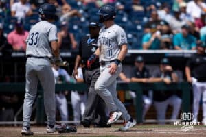 Arizona Wildcat outfielder Aaron Walton (11) scores stealing home on a passed ball against the Coastal Carolina Chanticleers in the fifth inning during the College World Series on Friday, June 13, 2025 in Omaha, Nebraska. Photo by John S. Peterson.