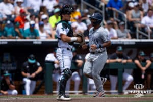 Arizona Wildcat catcher Adonys Guzman (18) scores a run against the Coastal Carolina Chanticleers in the fourth inning during the College World Series on Friday, June 13, 2025 in Omaha, Nebraska. Photo by John S. Peterson.