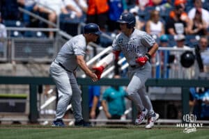 Arizona Wildcat infielder Mason White (24) gets five from coach Chip Hale during the College World Series on Friday, June 13, 2025 in Omaha, Nebraska. Photo by John S. Peterson.