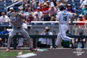 Arizona Wildcat catcher Tommy Splaine (20) forces out Coastal Carolina Chanticleer first baseman Colby Thorndyke (16) at first base in the third inning during the College World Series on Friday, June 13, 2025 in Omaha, Nebraska. Photo by John S. Peterson.
