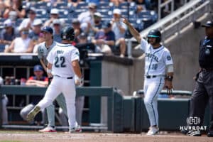 Coastal Carolina Chanticleer Blagen Pado (22) scores a run with Colby Thorndyke in the second inning against the Arizona Wildcats in the second inning during the College World Series on Friday, June 13, 2025 in Omaha, Nebraska. Photo by John S. Peterson.