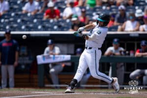 Coastal Carolina Chanticleer Colby Thorndyke (16) hits a double in the second inning Arizona Wildcats during the College World Series on Friday, June 13, 2025 in Omaha, Nebraska. Photo by John S. Peterson.