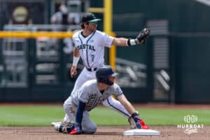 Arizona Wildcat outfielder Brendan Summerhill (4) steals second against Coastal Carolina Chanticleer infielder Blake Barthol (7) in the first inning during the College World Series on Friday, June 13, 2025 in Omaha, Nebraska. Photo by John S. Peterson.